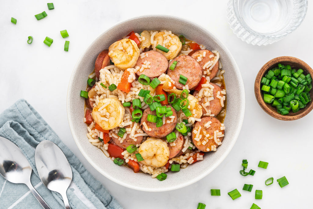 An overhead image of a Cajun orzo bowl made with shrimp, sausage, spices, and low-carb It's Skinny Orzo.