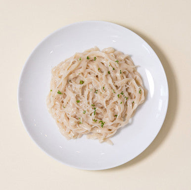 An overhead image of creamy fettuccine alfredo made with It's Skinny low carb Fettuccine pasta.